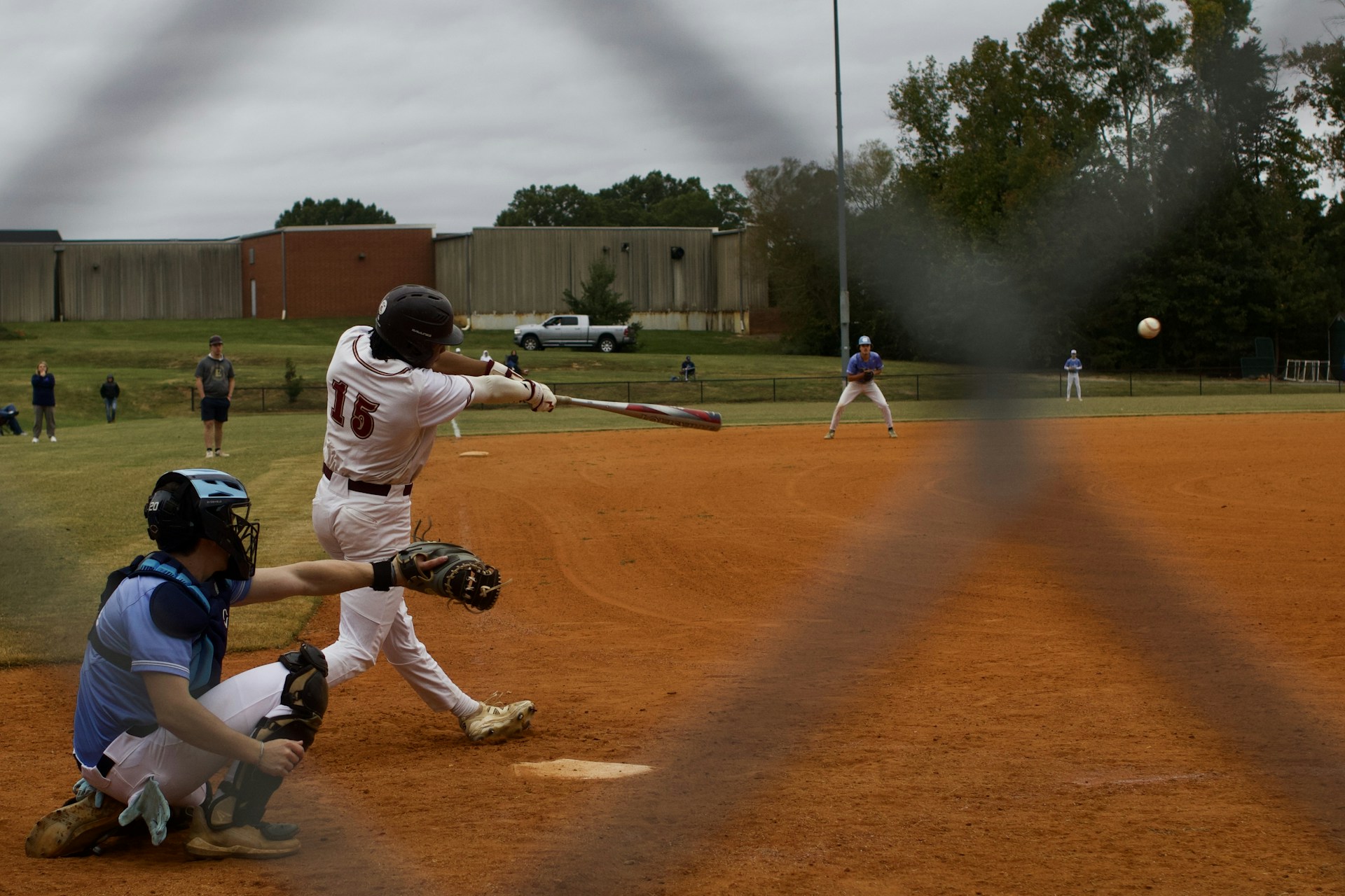 Baseball player swings at a pitch during a game — photo by Unsplash