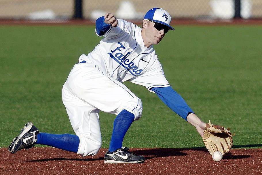 Youth infielder fielding a ground ball on the dirt infield